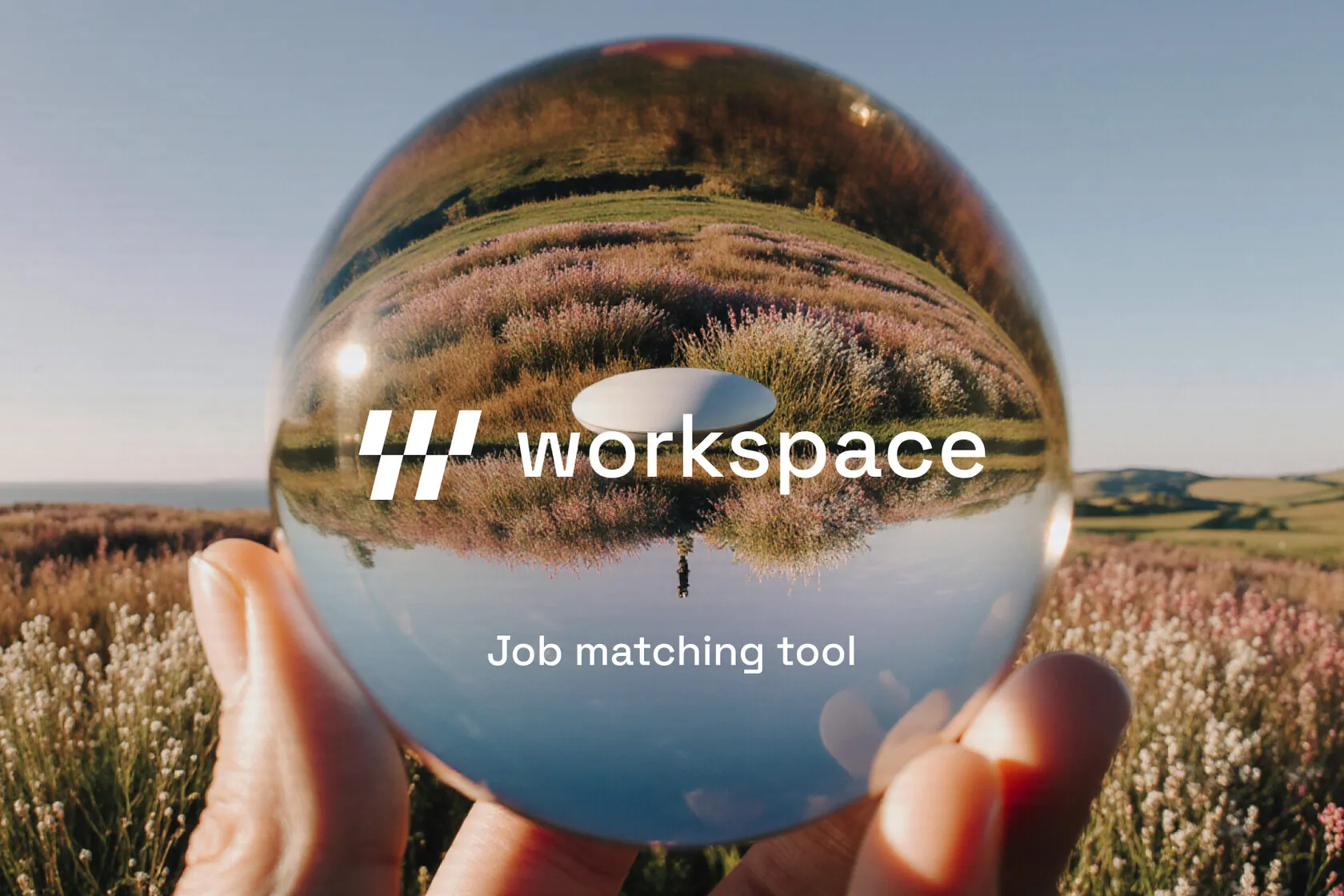 Hand holding a glass ball showing the Workspace logo and "Job matching tool" over a meadow